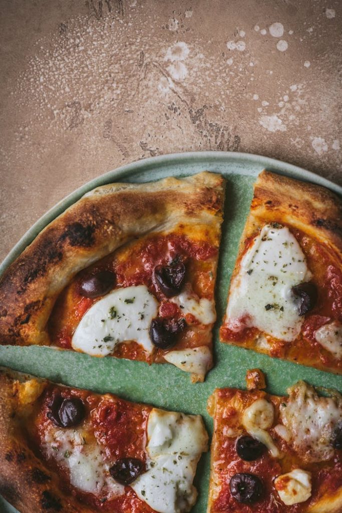 Appetizing view of a freshly baked Italian pizza with olives and mozzarella, perfect for a gourmet meal.